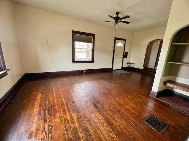 582 Spruce Ave, Sharon, PA 16146 - unfurnished room with arched walkways, hardwood / wood-style floors, ceiling fan, and baseboards