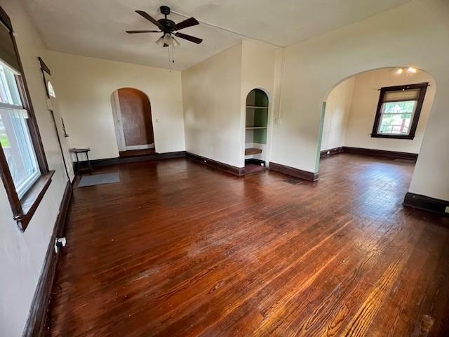 582 Spruce Ave, Sharon, PA 16146 - spare room with ceiling fan, dark wood-style flooring, arched walkways, and baseboards