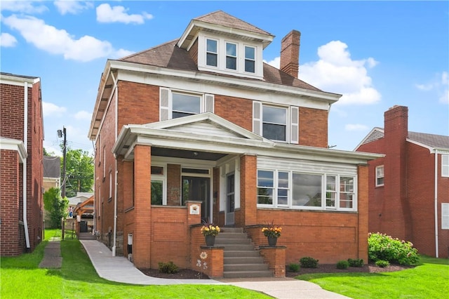 1622 Ridge Ave, Coraopolis, PA 15108 - american foursquare style home with brick siding, a chimney, a front yard, and covered porch