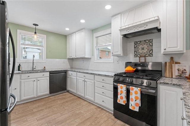 1622 Ridge Ave, Coraopolis, PA 15108 - kitchen with appliances with stainless steel finishes, a sink, under cabinet range hood, white cabinets, and tasteful backsplash