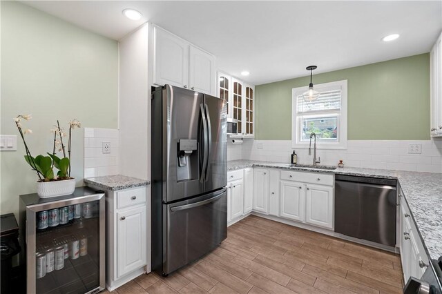 1622 Ridge Ave, Coraopolis, PA 15108 - kitchen with stainless steel appliances, a sink, beverage cooler, decorative backsplash, and recessed lighting