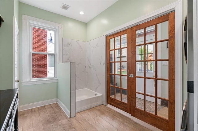 1622 Ridge Ave, Coraopolis, PA 15108 - bathroom featuring french doors, wood finished floors, a bathtub, baseboards, and a shower