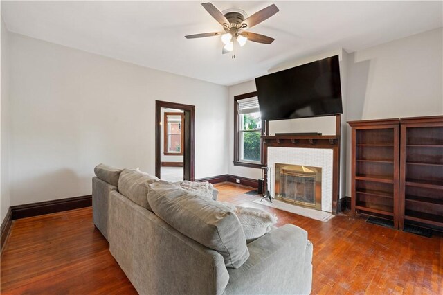 1622 Ridge Ave, Coraopolis, PA 15108 - living area featuring a ceiling fan, a tile fireplace, wood finished floors, and baseboards