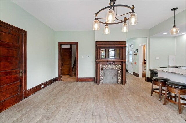 1622 Ridge Ave, Coraopolis, PA 15108 - kitchen featuring light wood-style flooring, baseboards, a chandelier, light stone countertops, and decorative light fixtures
