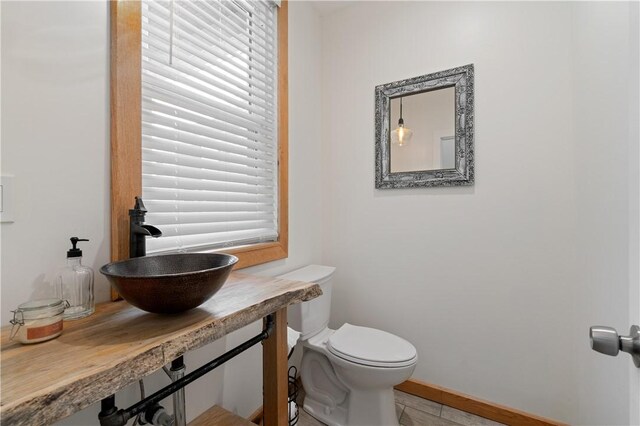 1622 Ridge Ave, Coraopolis, PA 15108 - half bath with a sink, toilet, and baseboards