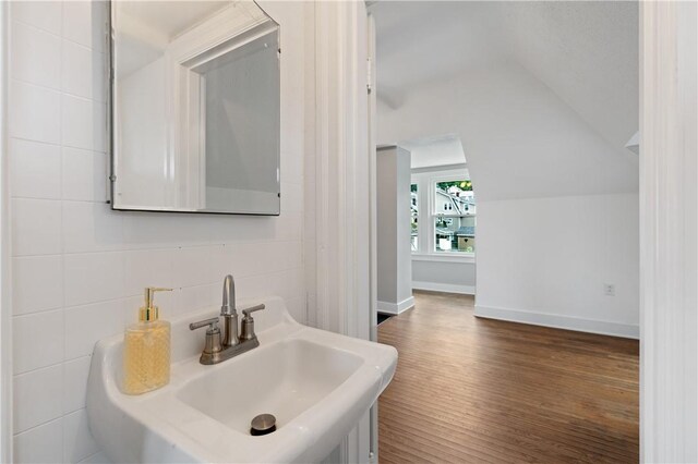 1622 Ridge Ave, Coraopolis, PA 15108 - bathroom featuring lofted ceiling, wood finished floors, a sink, and baseboards