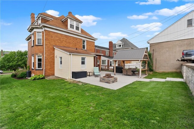 1622 Ridge Ave, Coraopolis, PA 15108 - back of property featuring an outdoor fire pit, a patio area, a yard, brick siding, and a chimney