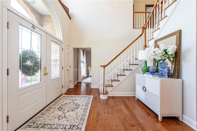 585 Agnes St, Hempfield Twp Wml, PA 15601 - entrance foyer with baseboards, stairway, wood finished floors, and a towering ceiling