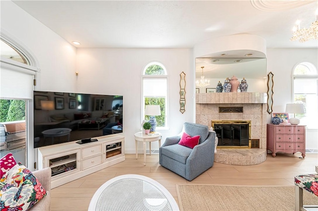 585 Agnes St, Hempfield Twp Wml, PA 15601 - living area featuring a chandelier, plenty of natural light, and a tiled fireplace