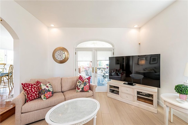 585 Agnes St, Hempfield Twp Wml, PA 15601 - living room featuring arched walkways, french doors, light wood-style floors, and recessed lighting
