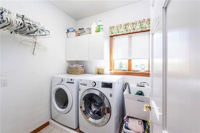 585 Agnes St, Hempfield Twp Wml, PA 15601 - laundry area featuring cabinet space, washing machine and clothes dryer, and light tile patterned floors