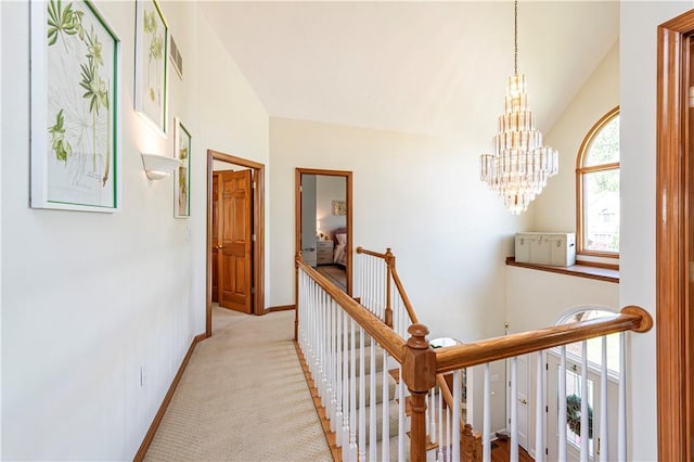 585 Agnes St, Hempfield Twp Wml, PA 15601 - hallway with an upstairs landing, a chandelier, baseboards, and light colored carpet