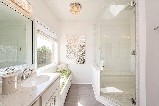 585 Agnes St, Hempfield Twp Wml, PA 15601 - full bathroom with a shower stall, baseboards, vanity, and wood finished floors