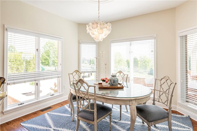 585 Agnes St, Hempfield Twp Wml, PA 15601 - dining space featuring a chandelier, baseboards, and wood finished floors