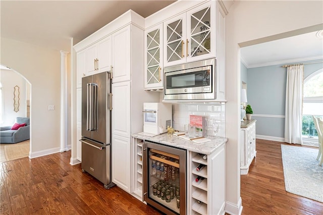585 Agnes St, Hempfield Twp Wml, PA 15601 - kitchen with appliances with stainless steel finishes, wine cooler, dark wood-style floors, arched walkways, and glass insert cabinets