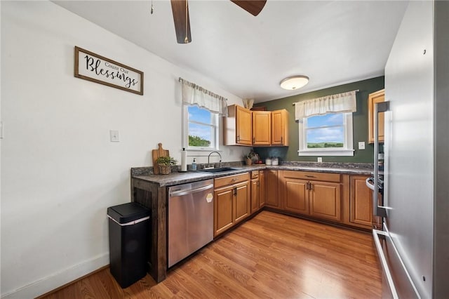 136 Isabella St, Derry Twp, PA 15717 - kitchen featuring dishwasher, a sink, dark countertops, light wood-style flooring, and ceiling fan