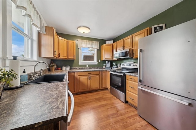 136 Isabella St, Derry Twp, PA 15717 - kitchen with appliances with stainless steel finishes, a sink, light wood finished floors, and dark countertops