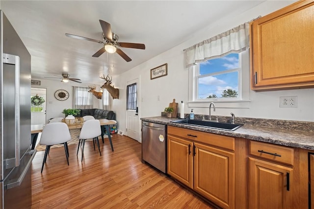 136 Isabella St, Derry Twp, PA 15717 - kitchen featuring appliances with stainless steel finishes, a sink, dark countertops, and light wood-type flooring