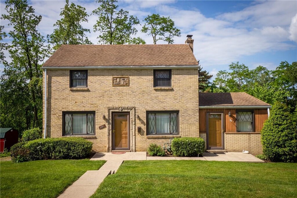 122 Heather Dr, Bethel Park, PA 15102 - colonial inspired home with a chimney, a front yard, and brick siding