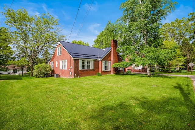 865 W Sanner St, Somerset Boro, PA 15501 - rear view of property with brick siding, a lawn, a chimney, and metal roof