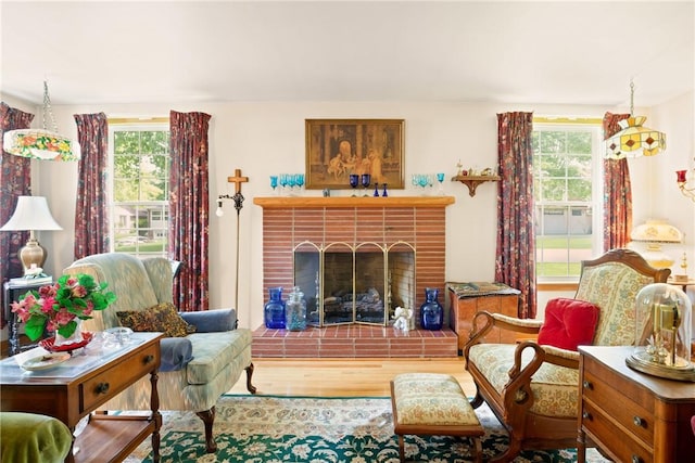 865 W Sanner St, Somerset Boro, PA 15501 - living area with plenty of natural light, a brick fireplace, and wood finished floors