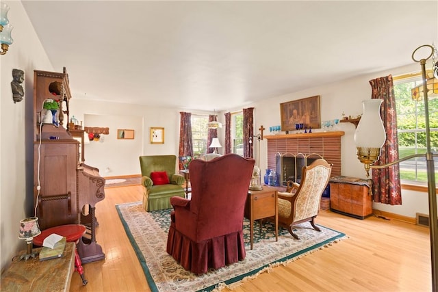 865 W Sanner St, Somerset Boro, PA 15501 - living room featuring wood finished floors, a brick fireplace, and baseboards