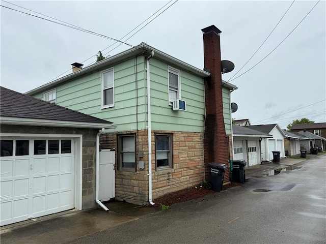 1335R 4th Ave, Ford City Boro, PA 16226 - view of side of home with a chimney, stone siding, and a garage