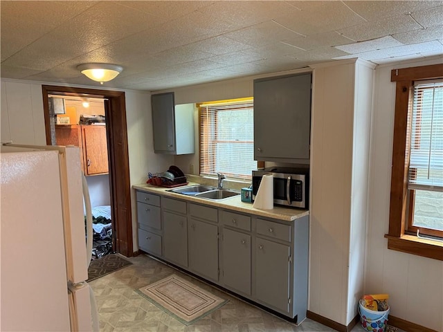 1335R 4th Ave, Ford City Boro, PA 16226 - kitchen featuring freestanding refrigerator, a sink, stainless steel microwave, gray cabinets, and light floors