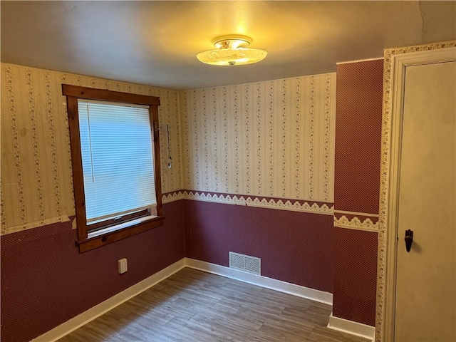 1335R 4th Ave, Ford City Boro, PA 16226 - empty room with wood finished floors, wallpapered walls, and baseboards
