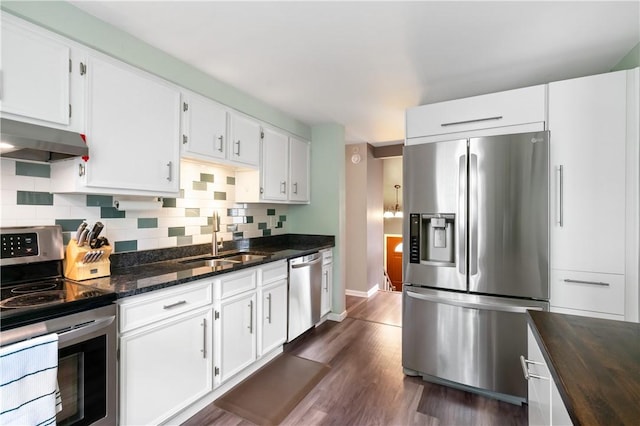 15 Fawnridge Dr, Robinson Twp Nwa, PA 15136 - kitchen featuring stainless steel appliances, a sink, wall chimney range hood, dark wood finished floors, and backsplash