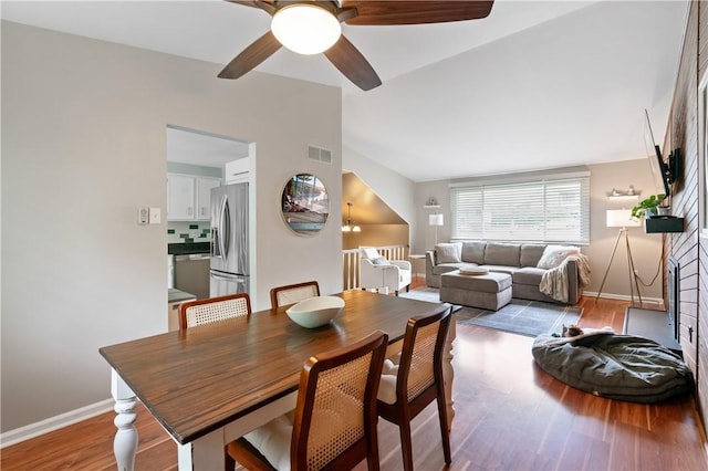 15 Fawnridge Dr, Robinson Twp Nwa, PA 15136 - dining room featuring ceiling fan, wood finished floors, baseboards, a brick fireplace, and vaulted ceiling