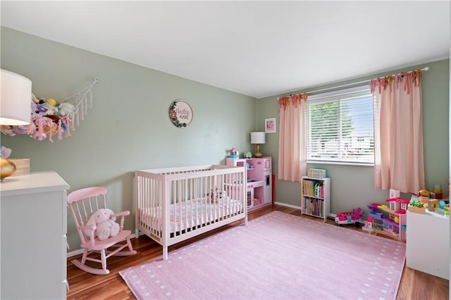 15 Fawnridge Dr, Robinson Twp Nwa, PA 15136 - bedroom featuring wood finished floors and a crib