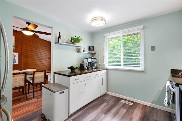 15 Fawnridge Dr, Robinson Twp Nwa, PA 15136 - kitchen with stainless steel appliances, dark countertops, ceiling fan, wooden walls, and open shelves
