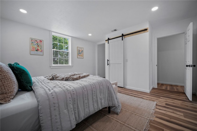 103 Depot St, Midway, PA 15060 - bedroom with a barn door, wood finished floors, recessed lighting, and baseboards