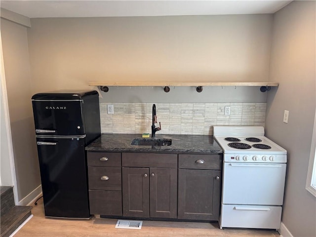 514 Knoll St, Central North Side, PA 15212 - kitchen featuring white range with electric stovetop, freestanding refrigerator, a sink, light wood-style floors, and dark brown cabinets