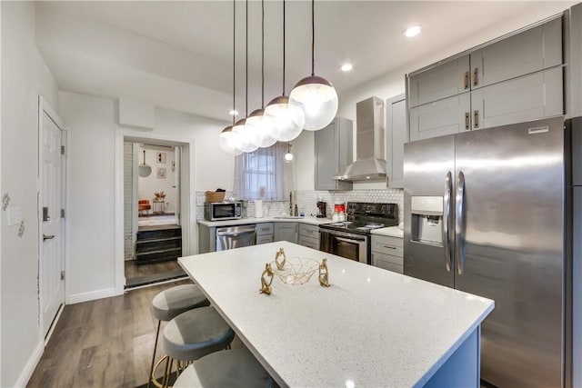 514 Knoll St, Central North Side, PA 15212 - kitchen with stainless steel appliances, wall chimney range hood, gray cabinetry, dark wood-type flooring, and decorative backsplash
