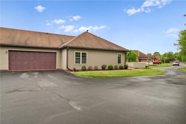 22 Ashford Dr, Cranberry Twp, PA 16066 - view of front facade featuring an attached garage, asphalt driveway, and a front lawn