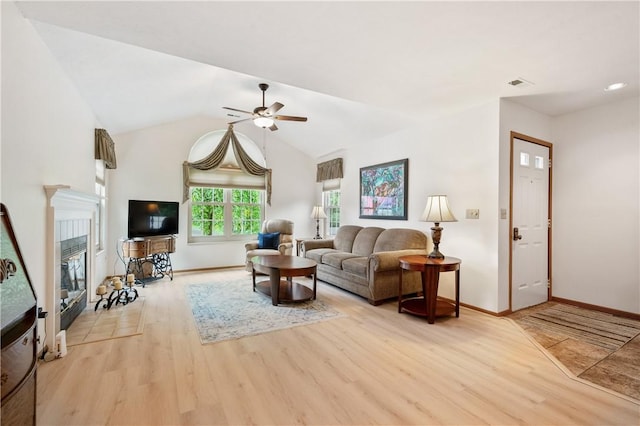 22 Ashford Dr, Cranberry Twp, PA 16066 - living room featuring a ceiling fan, baseboards, wood finished floors, a tiled fireplace, and vaulted ceiling