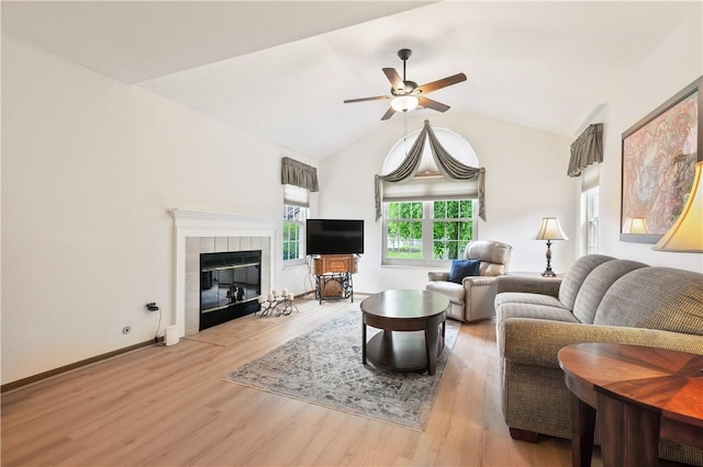 22 Ashford Dr, Cranberry Twp, PA 16066 - living room with a ceiling fan, wood finished floors, a tiled fireplace, vaulted ceiling, and baseboards