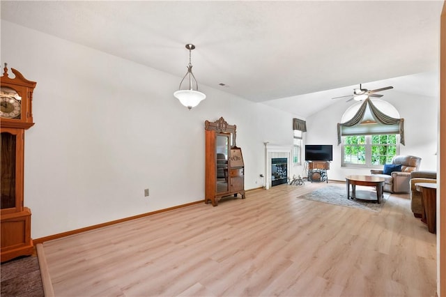 22 Ashford Dr, Cranberry Twp, PA 16066 - living room with light wood-style floors, a tile fireplace, ceiling fan, lofted ceiling, and baseboards