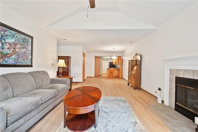 22 Ashford Dr, Cranberry Twp, PA 16066 - living room with light wood-style floors, a fireplace, vaulted ceiling, and ceiling fan