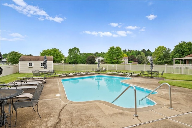 22 Ashford Dr, Cranberry Twp, PA 16066 - community pool with a patio area, an outbuilding, and view of wooded area