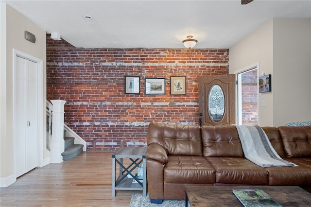 4232 Sherrod St, Lawrenceville, PA 15201 - living room with brick wall, wood finished floors, and stairway