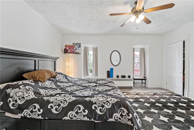 134 S 19th St, South Side, PA 15203 - bedroom with a textured ceiling, radiator heating unit, and a ceiling fan