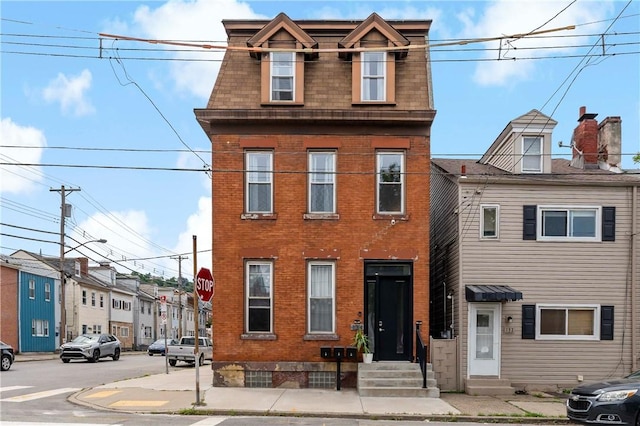 134 S 19th St, South Side, PA 15203 - view of front of house with entry steps, mansard roof, and brick siding