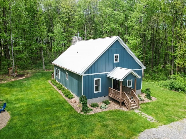 500 Shady Ln, Slippery Rock Twp Law, PA 16117 - view of front of home featuring a view of trees, a front lawn, a chimney, and covered porch