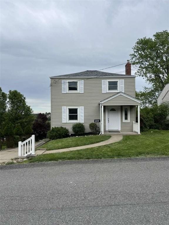 3309 Woodvue Dr, Whitehall, PA 15227 - traditional-style house with a chimney and a front yard