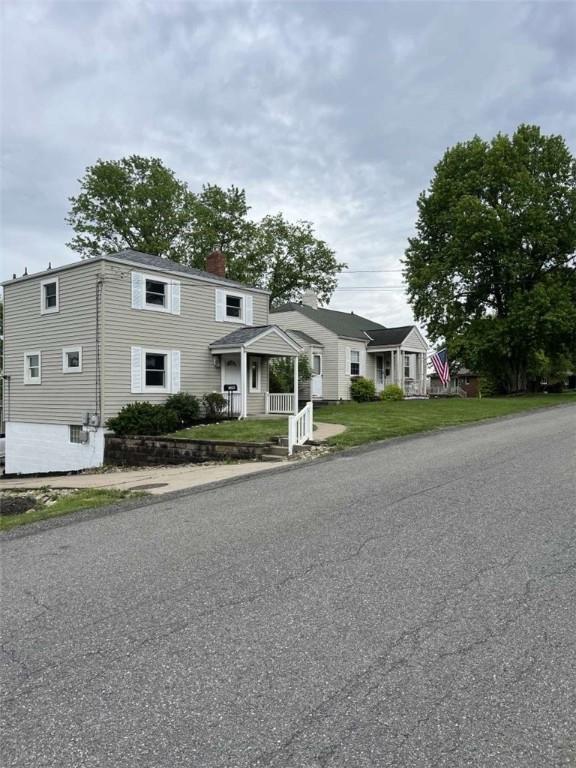 3309 Woodvue Dr, Whitehall, PA 15227 - view of front of home featuring a chimney and a front lawn