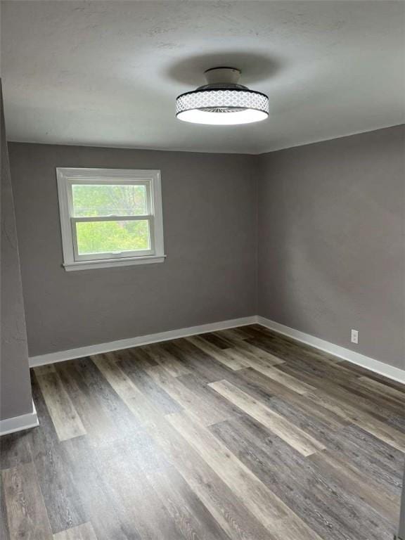 3309 Woodvue Dr, Whitehall, PA 15227 - spare room featuring wood finished floors and baseboards
