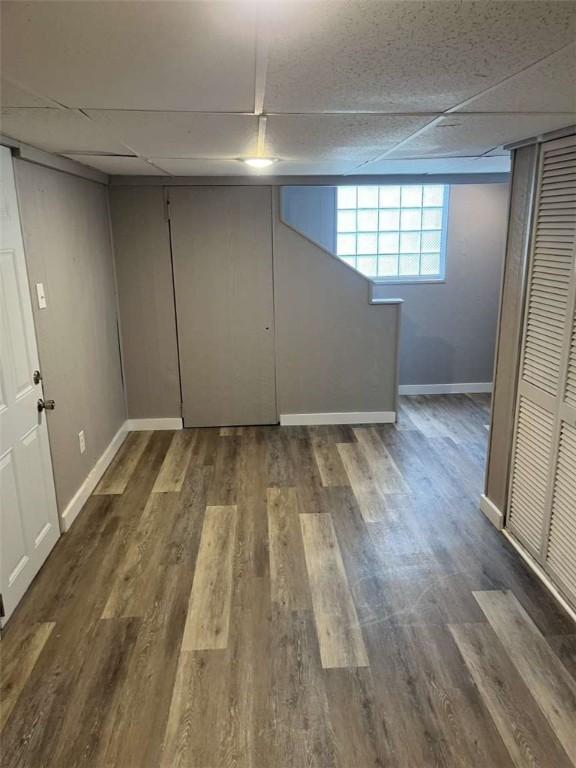 3309 Woodvue Dr, Whitehall, PA 15227 - below grade area with baseboards, a paneled ceiling, and wood finished floors